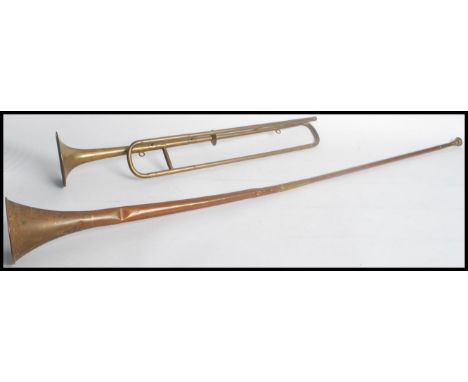 An early 20th century copper two part hunting horn along with a vintage trombone trumpet. Measures 126cms longest.