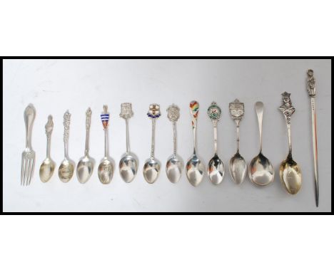 A collection of twelve silver hallmarked and continental silver spoons along with a silver 925 fork and a plated letter opene