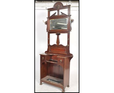 An Victorian Druce &amp; Co of London mahogany hall stand. Of unusual shaped upright form with central mirror glass flanked b