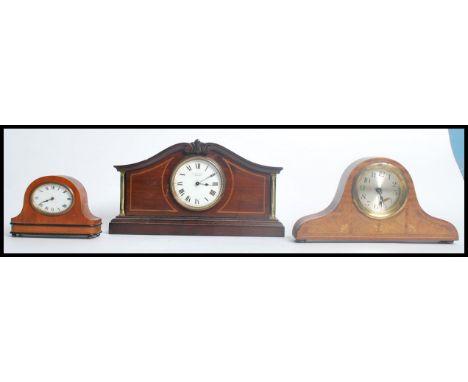 A group of three small mantle clocks one being an inlaid clock with scrolled top by T. Morris Turner Ashford having an enamel