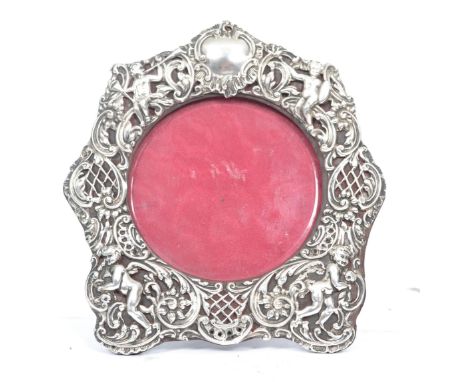 A 19th century Victorian silver hallmarked easel back picture frame of circular form. The central glass panel&nbsp;housed wit