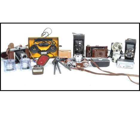 A collection of vintage cameras to include a West German Petie camera, lenses, Folding Ensign camera, Kodak, Boxed Brownie 8 