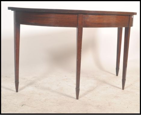 A 19th century Georgian Regency mahogany console D end table raised on tapered square legs with inlay design.