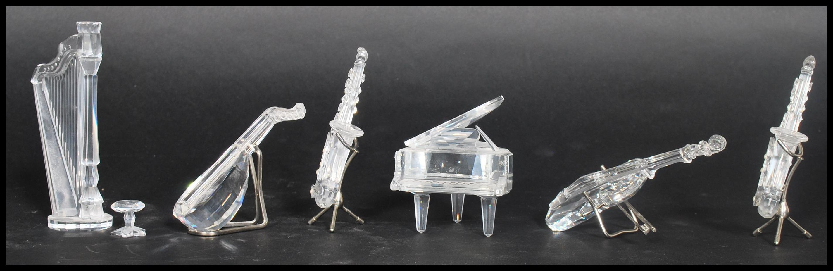 A group of six Swarovski faceted crystal glass musical instruments to