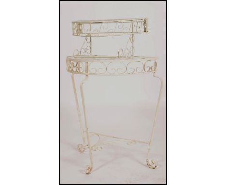 2 retro mid century painted wrought metal console tables. Each with painted white finish in the rococo style with mottled gla