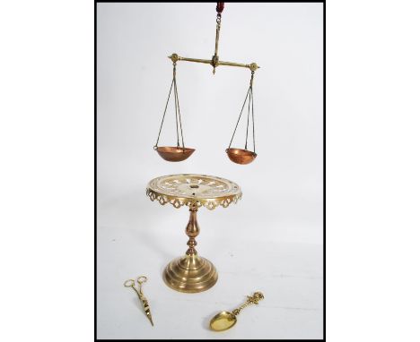 A late 19th century brass tazza / cake stand, raised on a turned base with an ecclesiastical fret pierced top together with a