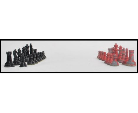 A vintage early 20th century chess set of lead construction consisting of red and black painted pieces. Highest 5cms.
