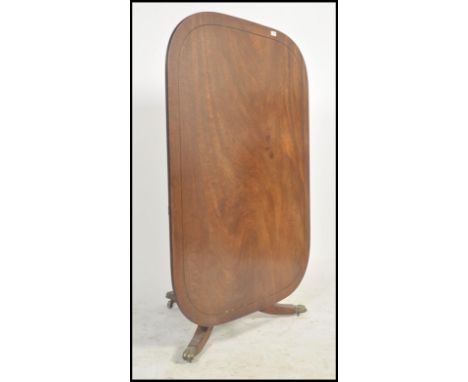 A good Regency revival mahogany tilt top / loo table with brass castors having reeded tripod base with rectangular tilt top a