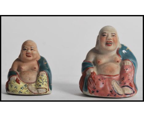 Two Chinese miniature ceramic laughing Buddha's having polychrome decoration and impressed and painted marks to base. Highest