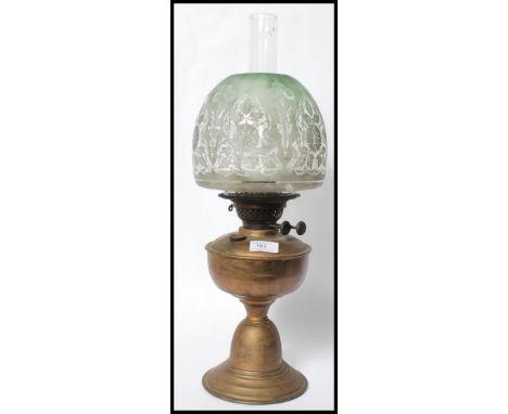 An early 20th century oil lamp complete with the glass flue and acid etched shade of colourful form with etched decoration. M