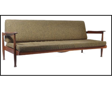 A Manhattan style sofa / day bed, by Guy Rodgers, the teak frame three-seat sofa converts to a flat bed, upholstered with a r