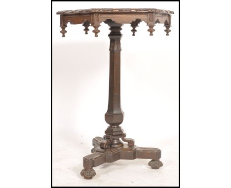 A 19th century Victorian carved oak wine table of hexagonal form. Raised on a carved tripod base with hexagonal column.