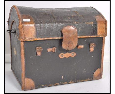 A vintage early 20th century dome top steamer travel trunk with belt loop catches to front. Measures 55cm x 60cm x 50cm.