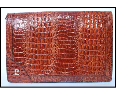A vintage Pierre Cardin retro alligator skin ladies clutch handbag with multiple zipped compartments to the interior and make