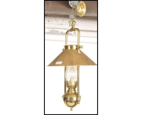 A vintage 20th century brass porch lantern in the form of an early carriage lamp with pendant top and glass flute.&nbsp;Measu