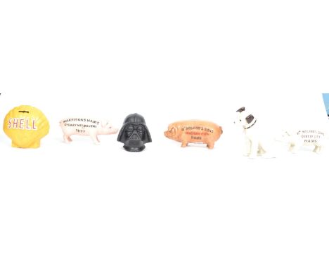 A group of six vintage 20th century cast iron money boxes banks to include three advertising pig examples and three others.