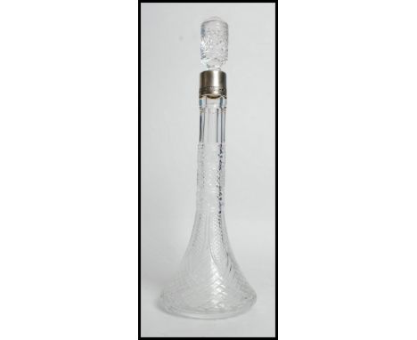 A good cut glass decanter of slim proportions having a silver white metal being stamped 875. measures 33cms high
