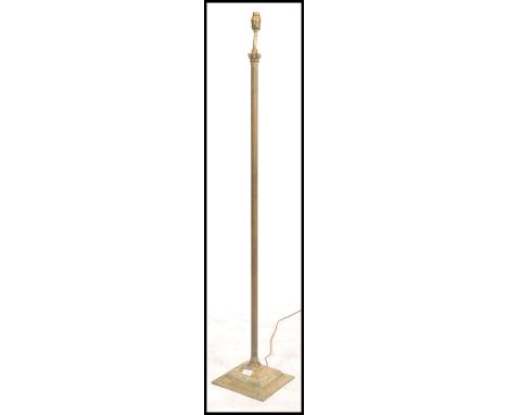 An early 20th century standard lamp of gilt metal ormulu form raised on squared terraced base with reeded column upright. Mea