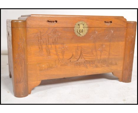 A mid century, circa 1950's camphor wood Chinese trunk / blanket box having panel sides with hinged top, all over carved deta