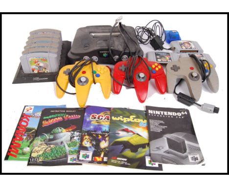 An original retro Nintendo 64 games console to include; 3x controllers, power cables &amp; a collection of games to include M