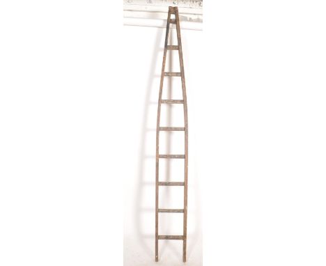A 20th century vintage solid pine painted industrial fruit pickers ladder of tapering form with steps to centre