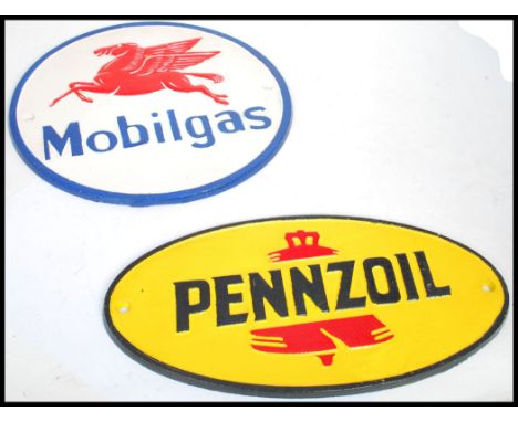 A pair of vintage style cast metal point of sale advertising garage wall plaques for Mobilgas and Pennzoil both featuring ico