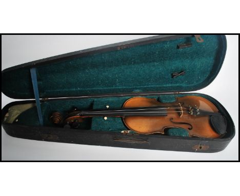 A 20th century Antonius Stradivarius violin and bow within fitted case. Paper label to interior.