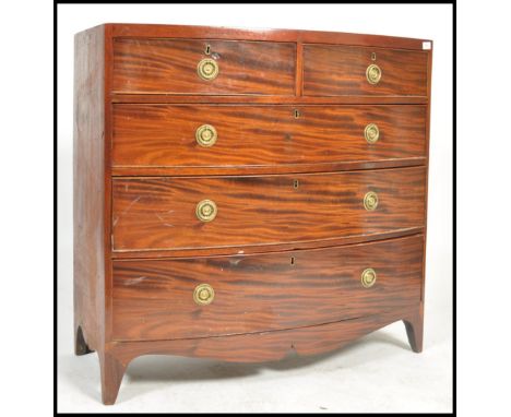 A 19th century Georgian mahogany bow front chest of two short over three long drawers, pine lined with circular plate and rin