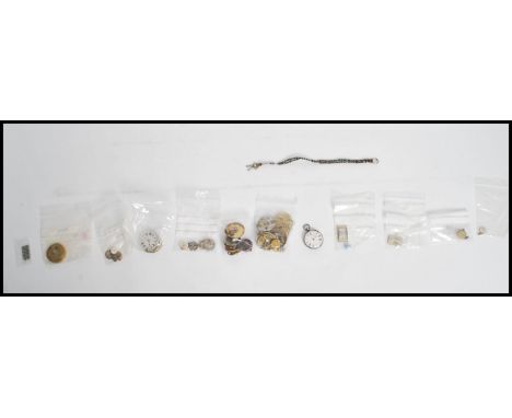 A collection of vintage pocket watch movements in parts together with a collection of wristwatch movement , other small watch