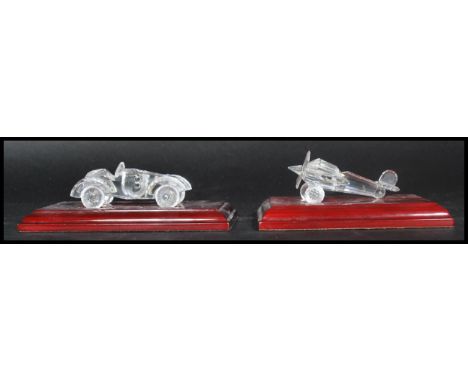 Swarovski faceted glass crystal model of a old timer car and a aeroplane having wooden plinth bases. Measures 6cms highest, 1