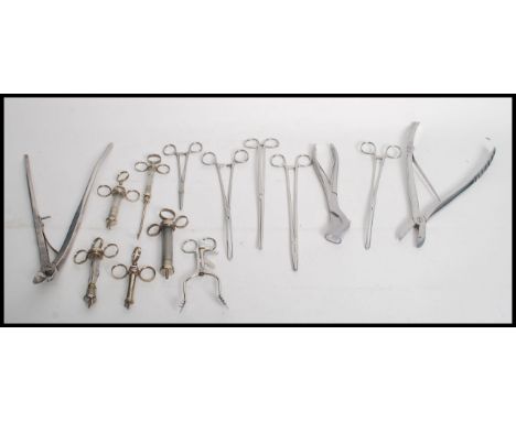A group of vintage 20th century medical surgical tools to include needles, scissors etc.