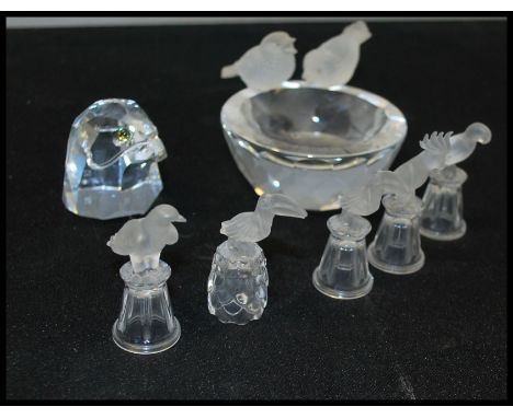 A group of Swarovski bird figurines to include a frosted and cut faceted glass bird bath figurine group, an eagle head paperw