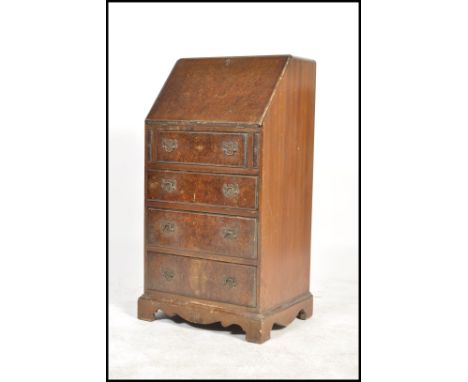 A 20th century Queen Anne revival walnut ladies bureau with fall front over chest of drawers and raised on bracket feet. Meas