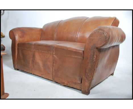 A stunning 1930's Art Deco&nbsp;Moustache back club 3 seat sofa in brown distressed leather being raised on straight legs and