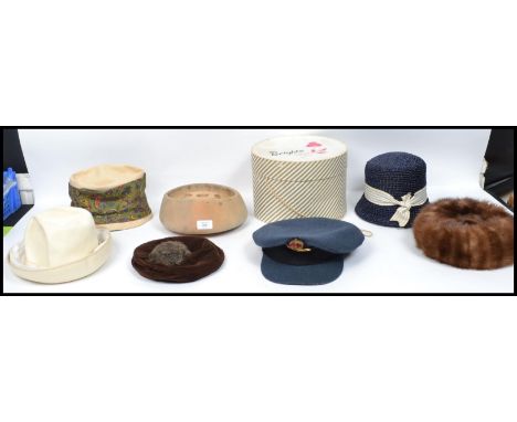 A collection of vintage 20th century ladies hats together with a Flight Lieutenants cap ( dated 1945 ) also with the original