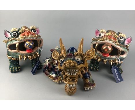 PAIR OF CHINESE CERAMIC DOGS, 20cm high, along with another similar figure (3)