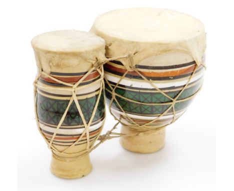 A twin bongo, with two ceramic bottom, on calf skin top, 18cm high, 22cm wide.