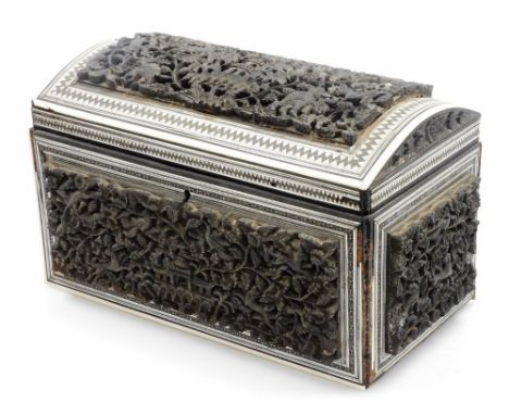 A 19thC heavily carved Anglo Indian padouk and sadeli double tea caddy, with domed top, with fitted interior, the exterior pr