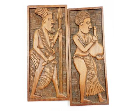 Two 20thC African tribal carved panels, the first figure in flowing robes holding vessel, the other figure holding spear, wit