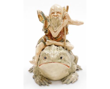 An unusual Japanese Satsuma group of a Gama Sennin seated upon his giant toad, Meiji period. 28cm high.