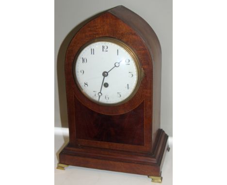 Fine Edwardian mahogany lancet shaped mantle clock with French movement raised on four brass bracket feet. Measures 35cm by 2