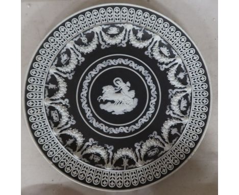 A 19th century Wedgwood black jasperware trophy plate, with a central rounded of Cynisca of Sparta - There is a small chip to