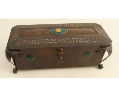 An Arts and Craft copper box, of rectangular form, the top with oval enamel panel of a flower and leaves, with embossed lette