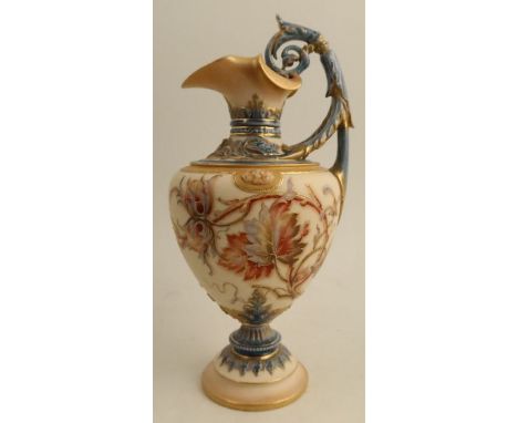 A Royal Worcester pedestal ewer, decorated with flowers to a gilded ivory ground, shape number 1309, height 10.25ins - the gi