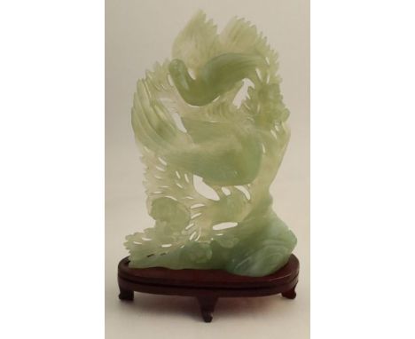A jade study, of two Phoenix against a foliate background, height including stand 10ins