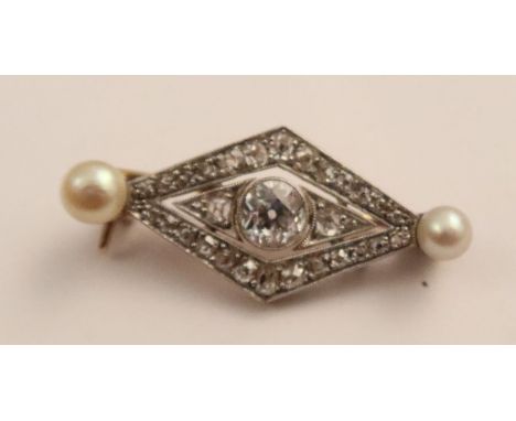 An Edwardian diamond and pearl broach, of lozenge shape, having central old cut&nbsp; diamond approx. 6.00mm diameter, with m