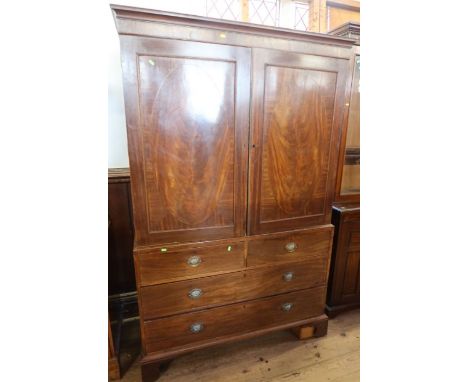 A 19th century mahogany linen press, the upper section having a pair of fielded doors opening to reveal a hanging space (orig