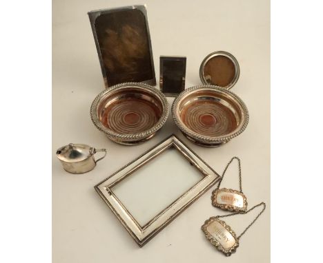 Four silver mounted photograph frames, of various shapes and sizes, together with a pair of Sheffield plated bottle coasters,