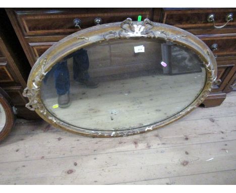 An oval gilt framed mirror