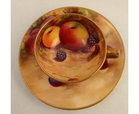 A Royal Worcester miniature cup and saucer, the interior of the cup and the saucer decorated with fruit to a mossy background